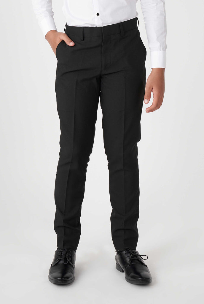 Teen wearing black tuxedo, zoomed in at pants