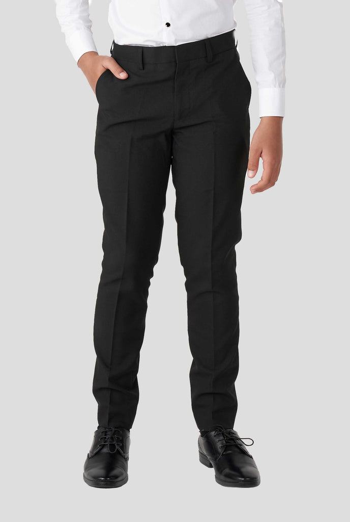 Teen wearing white and black tuxedo, zoomed in on pants