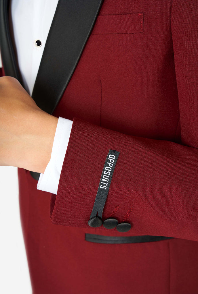 Teen wearing burgundy red and black tuxedo, close up