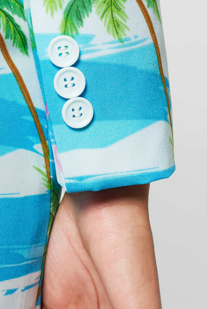 Woman wearing tropical blue suit with flamingo print, sleeve close up